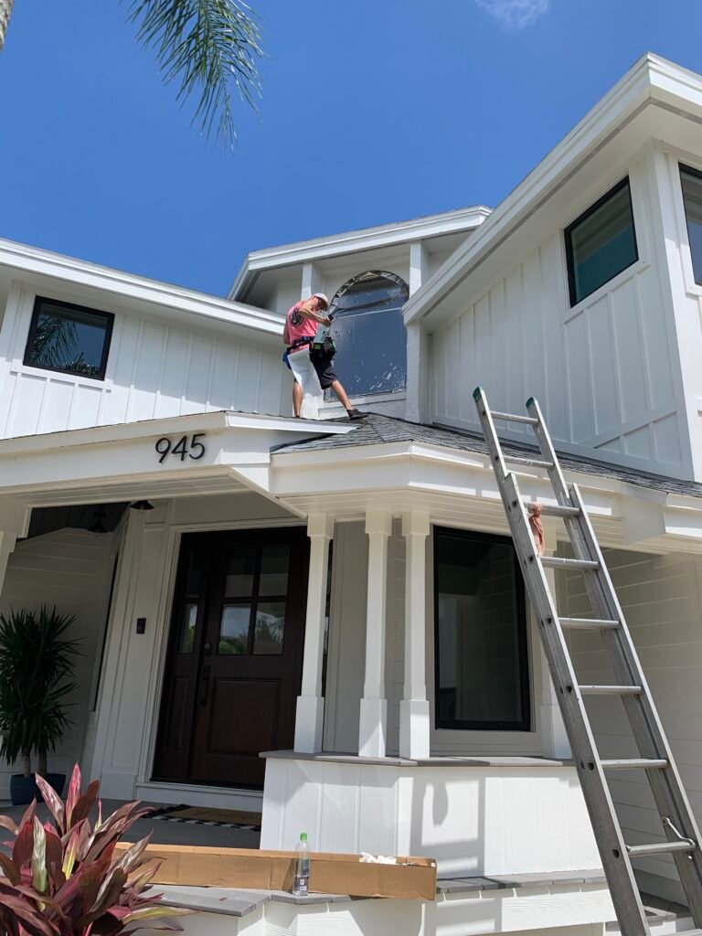 Tint by the Bay installing residential window film on a two-story home in Pinellas County Florida
