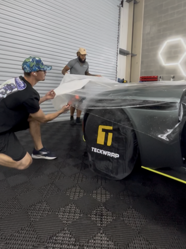 Paint protection film positioned across the front end of an Aston Martin DB11